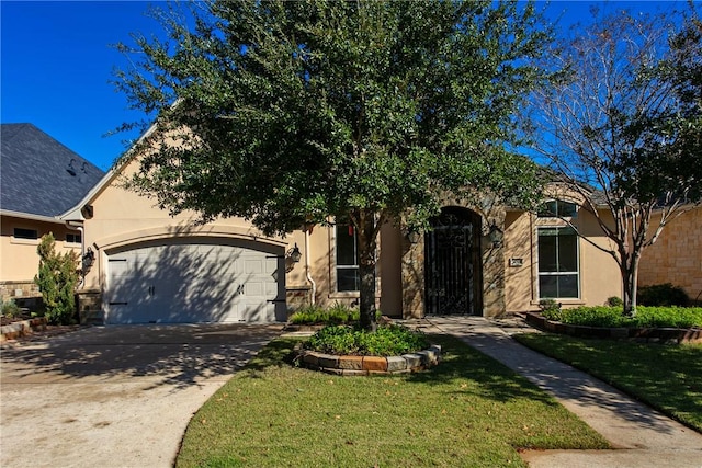 view of front of house with a garage and a front yard