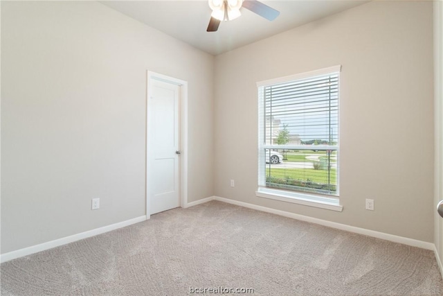 empty room featuring plenty of natural light, ceiling fan, and carpet floors