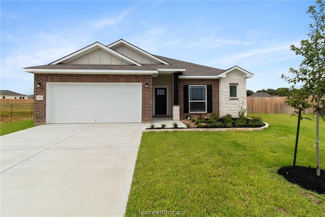 view of front of property with a garage and a front yard