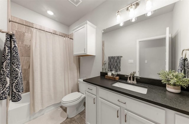 full bath featuring toilet, vanity, and shower / bath combo with shower curtain