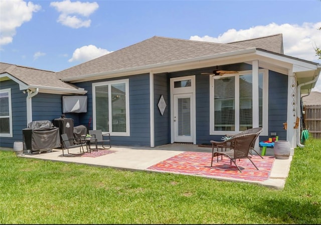 rear view of property featuring a patio area and roof with shingles