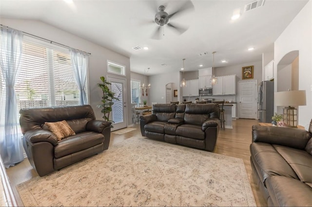 living area featuring ceiling fan, light wood-style flooring, a chandelier, and recessed lighting