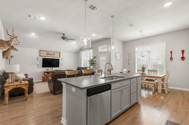 kitchen featuring dishwasher, a sink, baseboards, light wood-style flooring, and recessed lighting