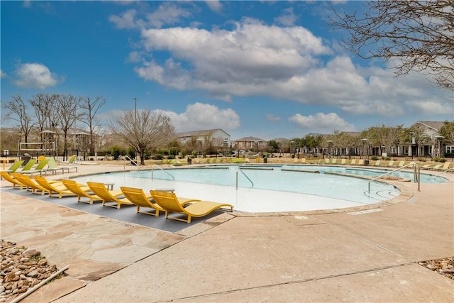 pool featuring a residential view and a patio