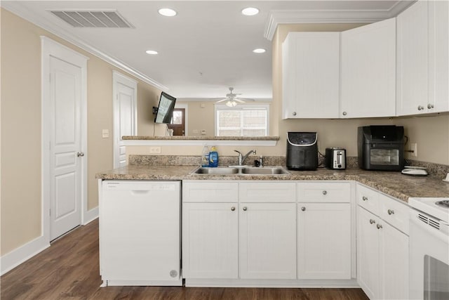 kitchen with white appliances, visible vents, a sink, dark wood-type flooring, and white cabinets