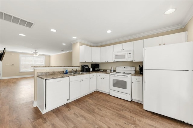 kitchen featuring visible vents, crown molding, a peninsula, white cabinets, and white appliances