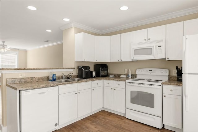 kitchen featuring ornamental molding, a peninsula, white cabinets, white appliances, and a sink