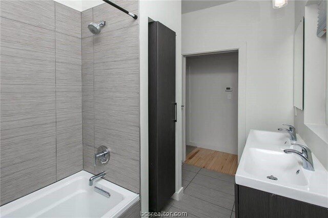 bathroom with vanity, tile patterned floors, and tiled shower / bath