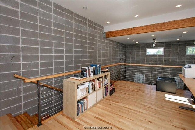 interior space with hardwood / wood-style floors and tile walls