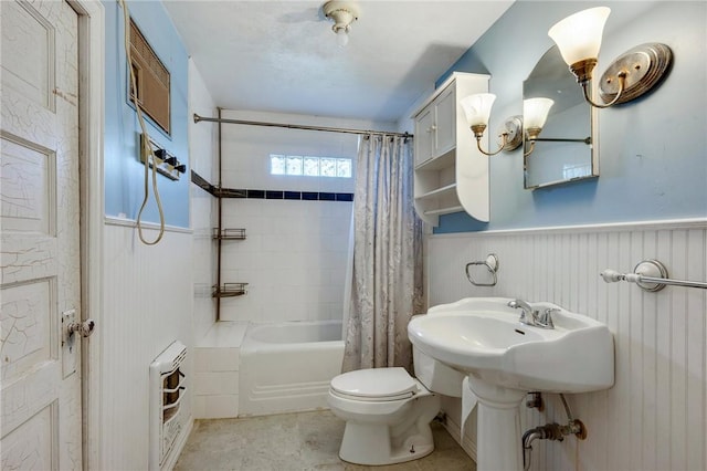 bathroom featuring toilet, a wainscoted wall, and shower / bathtub combination with curtain