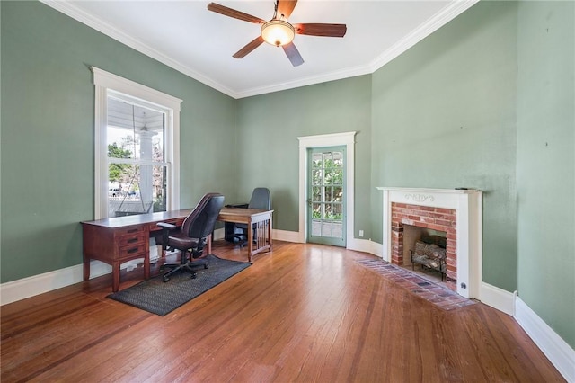 office with wood-type flooring, baseboards, ornamental molding, and a ceiling fan