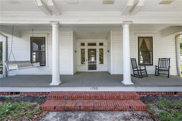 doorway to property featuring covered porch