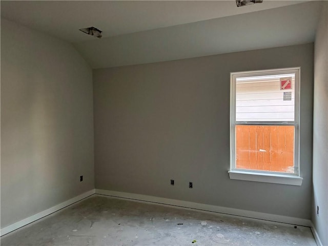 spare room with vaulted ceiling and a wealth of natural light