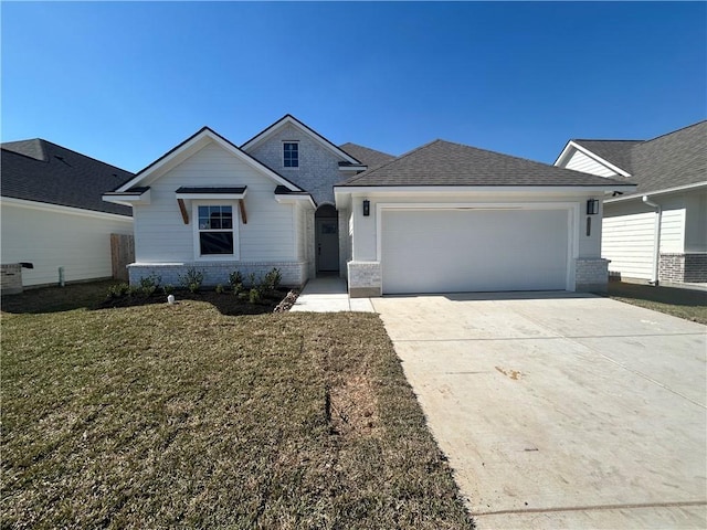 view of front facade featuring a garage, brick siding, driveway, roof with shingles, and a front yard