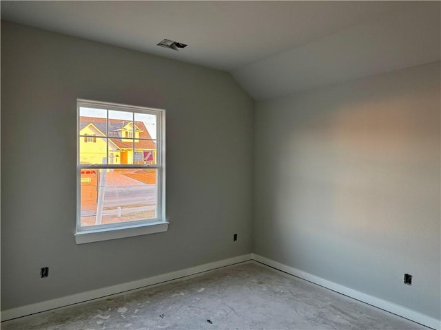 empty room featuring vaulted ceiling