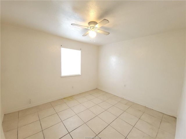 tiled spare room with ceiling fan