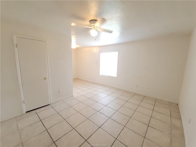 unfurnished room featuring light tile patterned floors and ceiling fan