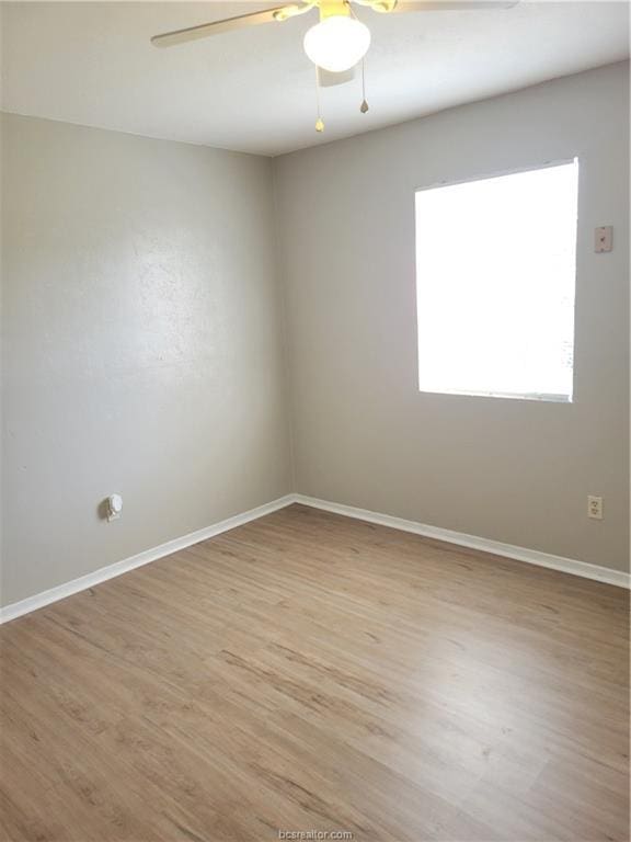 unfurnished room with ceiling fan and light wood-type flooring