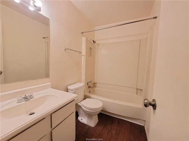 full bathroom with washtub / shower combination, toilet, wood-type flooring, and vanity