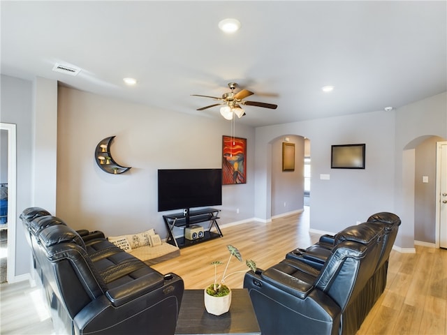 living room featuring light hardwood / wood-style flooring and ceiling fan