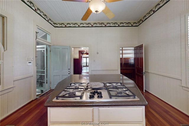 kitchen featuring dark hardwood / wood-style flooring, white cabinetry, stainless steel gas cooktop, and ceiling fan