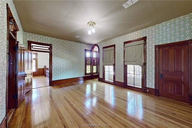 interior space featuring a healthy amount of sunlight, french doors, and light hardwood / wood-style flooring