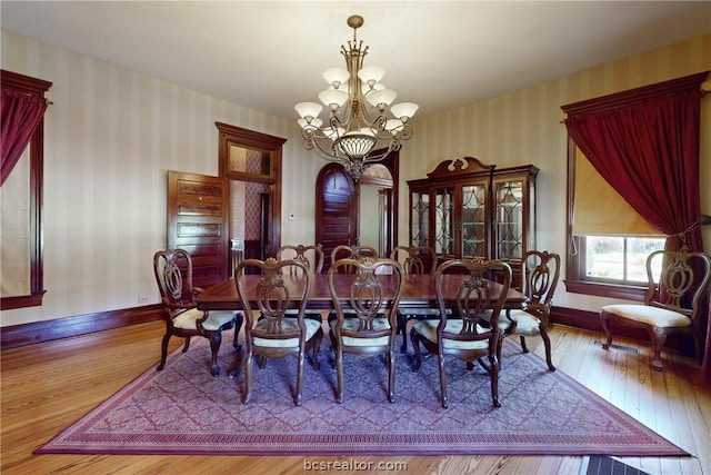 dining room featuring hardwood / wood-style flooring and a notable chandelier