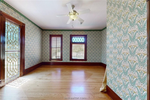 unfurnished room featuring ceiling fan, light hardwood / wood-style flooring, and ornamental molding