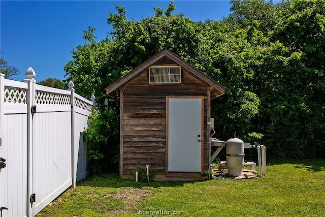 view of outbuilding featuring a yard