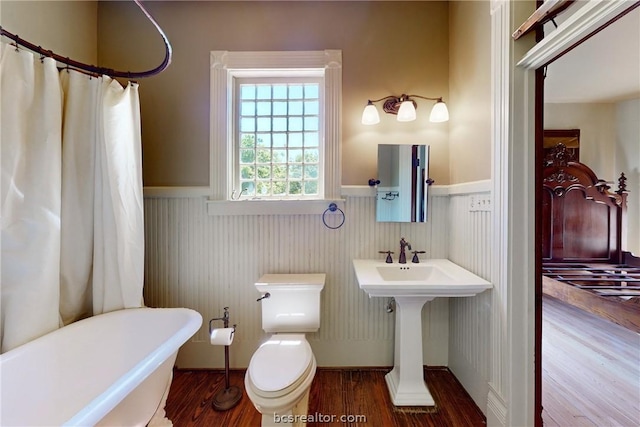 full bathroom featuring sink, hardwood / wood-style floors, independent shower and bath, and toilet