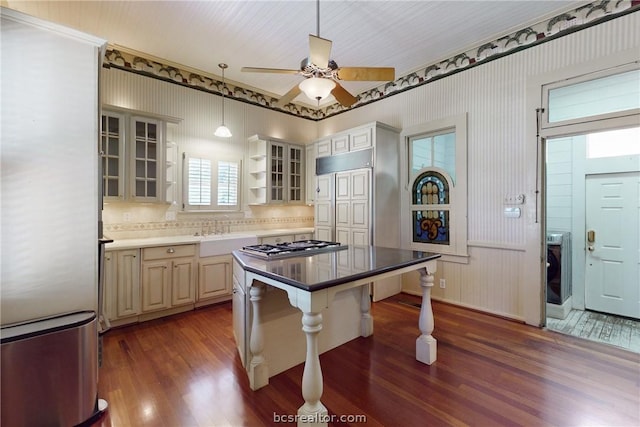 kitchen featuring a center island, a kitchen breakfast bar, tasteful backsplash, dark hardwood / wood-style flooring, and stainless steel appliances