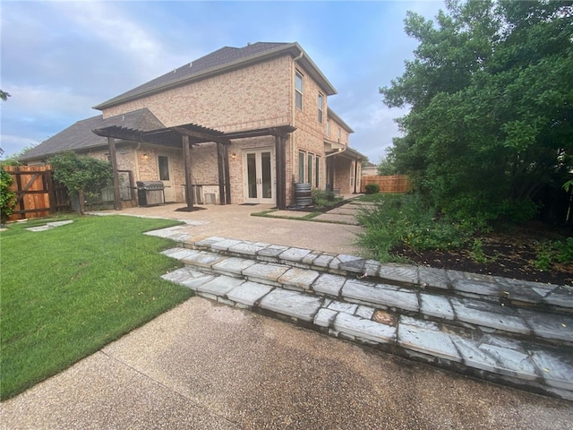 5311 Riviera Ct, College Station, TX 77845 - back of house with french doors, brick siding, a patio area, and a pergola