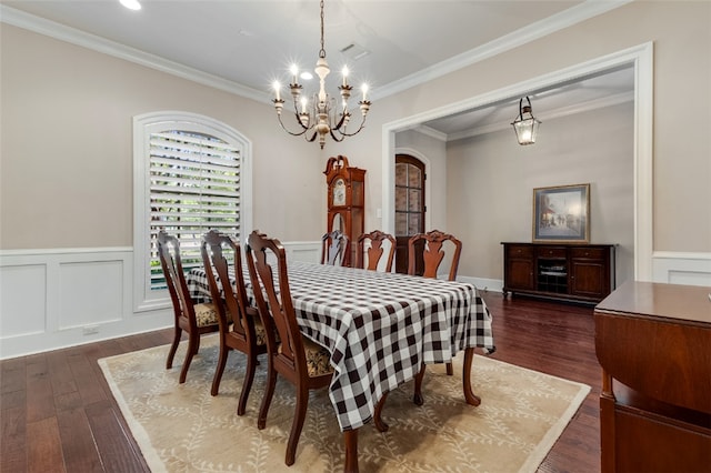 5311 Riviera Ct, College Station, TX 77845 - dining space featuring a chandelier, dark wood-style floors, wainscoting, arched walkways, and crown molding