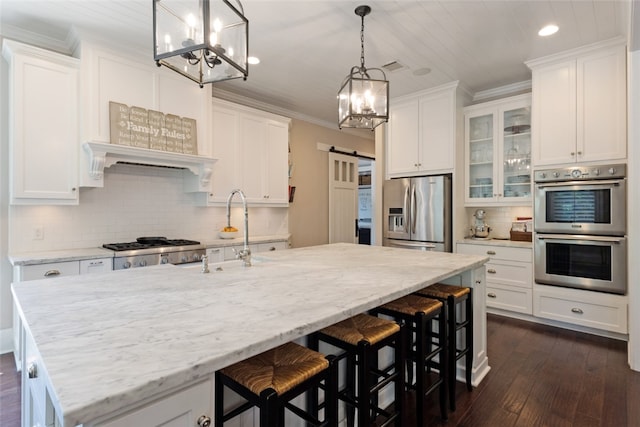 5311 Riviera Ct, College Station, TX 77845 - kitchen featuring stainless steel appliances, a chandelier, white cabinets, recessed lighting, and ornamental molding