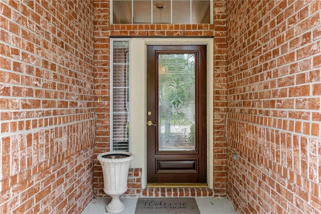 property entrance with brick siding
