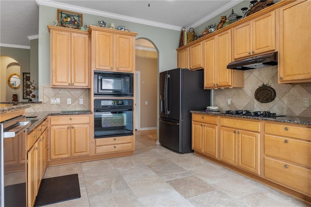 kitchen with under cabinet range hood, arched walkways, dark stone counters, and black appliances