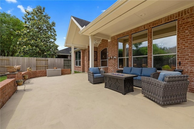 view of patio featuring a fenced backyard and an outdoor living space with a fire pit
