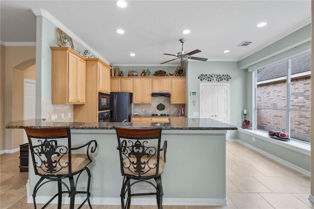 kitchen with a ceiling fan, backsplash, arched walkways, black appliances, and a peninsula