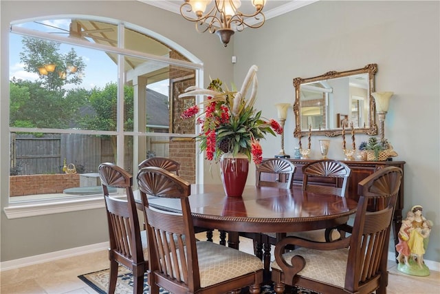 dining area featuring crown molding, baseboards, and a notable chandelier