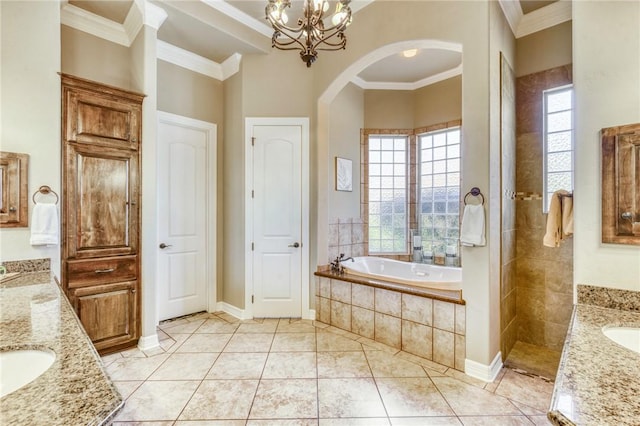 bathroom featuring tile patterned floors, crown molding, a sink, two vanities, and a bath