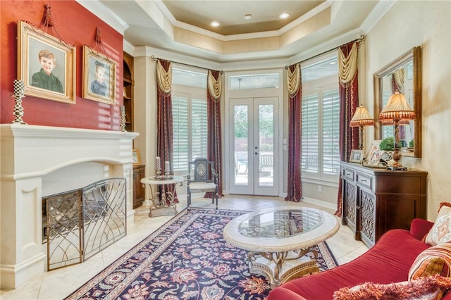 interior space with a fireplace with flush hearth, crown molding, a tray ceiling, french doors, and light tile patterned floors