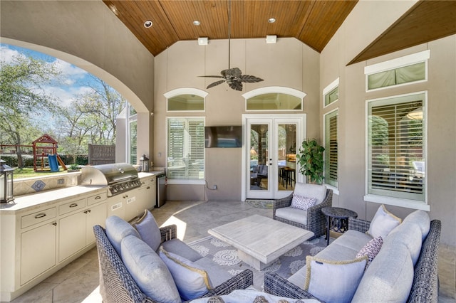 view of patio / terrace with an outdoor living space, french doors, a ceiling fan, grilling area, and a playground
