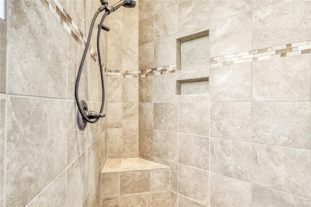 bathroom with a tile shower