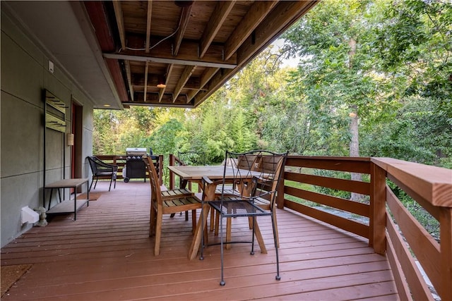 wooden terrace featuring a grill