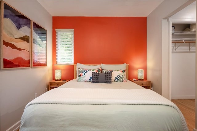 bedroom featuring hardwood / wood-style floors and a closet