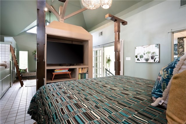 bedroom with multiple windows, high vaulted ceiling, and light tile patterned floors