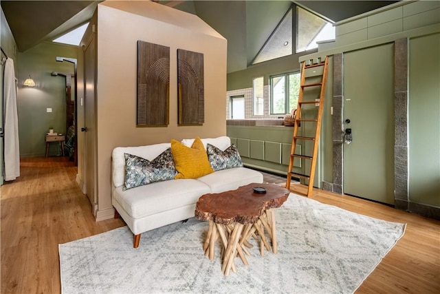 living room with hardwood / wood-style flooring and high vaulted ceiling