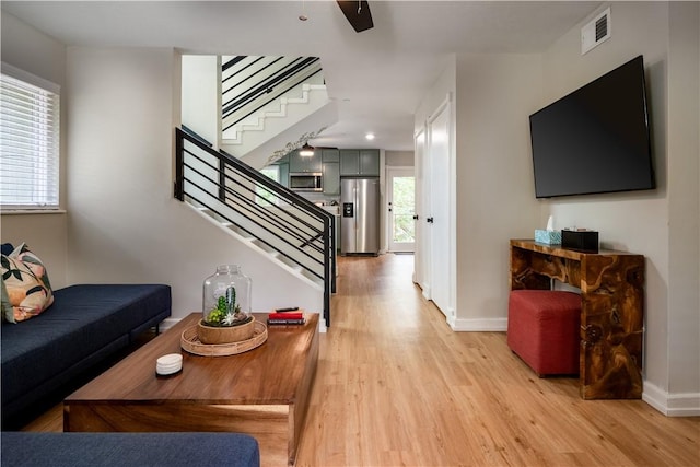 living room with plenty of natural light and light hardwood / wood-style floors