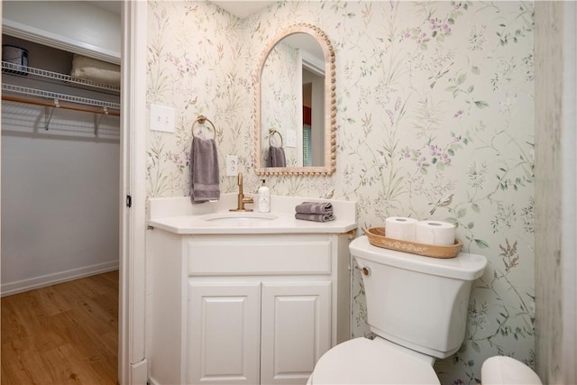 bathroom featuring hardwood / wood-style floors, vanity, and toilet