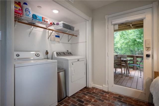 clothes washing area with washing machine and dryer